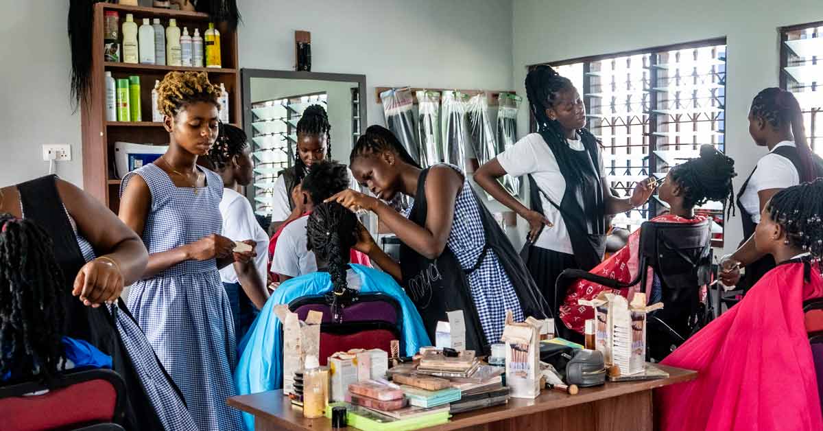 Girls at a trade school in Ghana practice styling hair