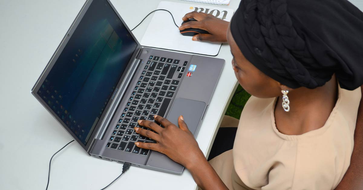 An overhead view of a woman on a laptop computer