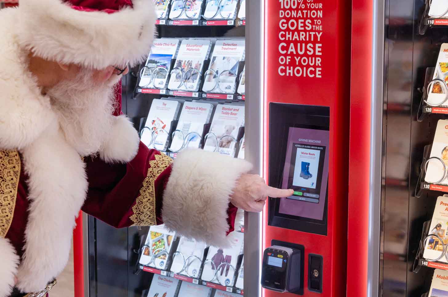 Santa Claus uses a Light the World Giving Machine