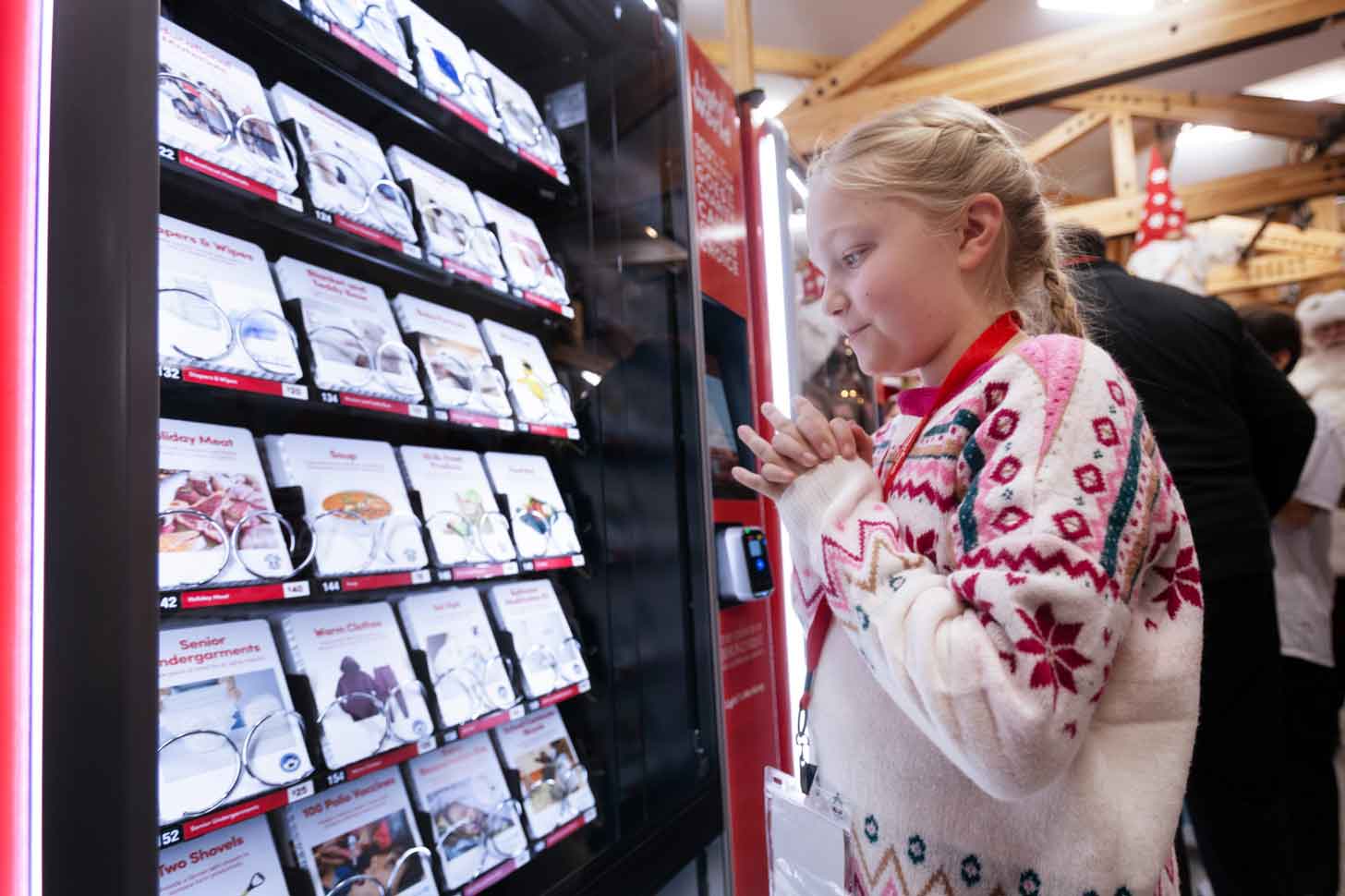 A young girl looks into a Light the World Giving Machine