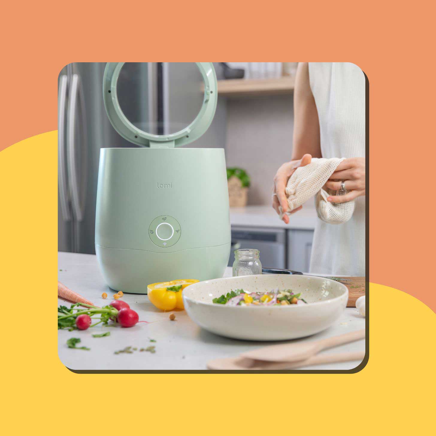 A mint green Lomi 3 countertop composter