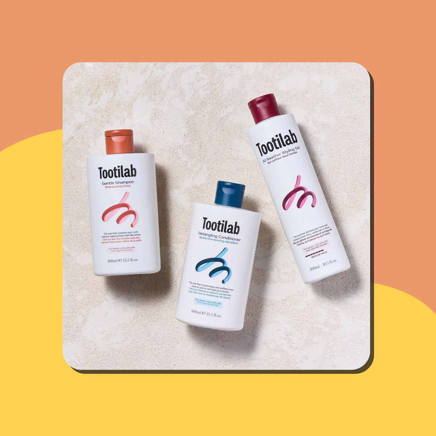 Bottles of Tootilab shampoo, conditioner, and styling gel on a granite countertop