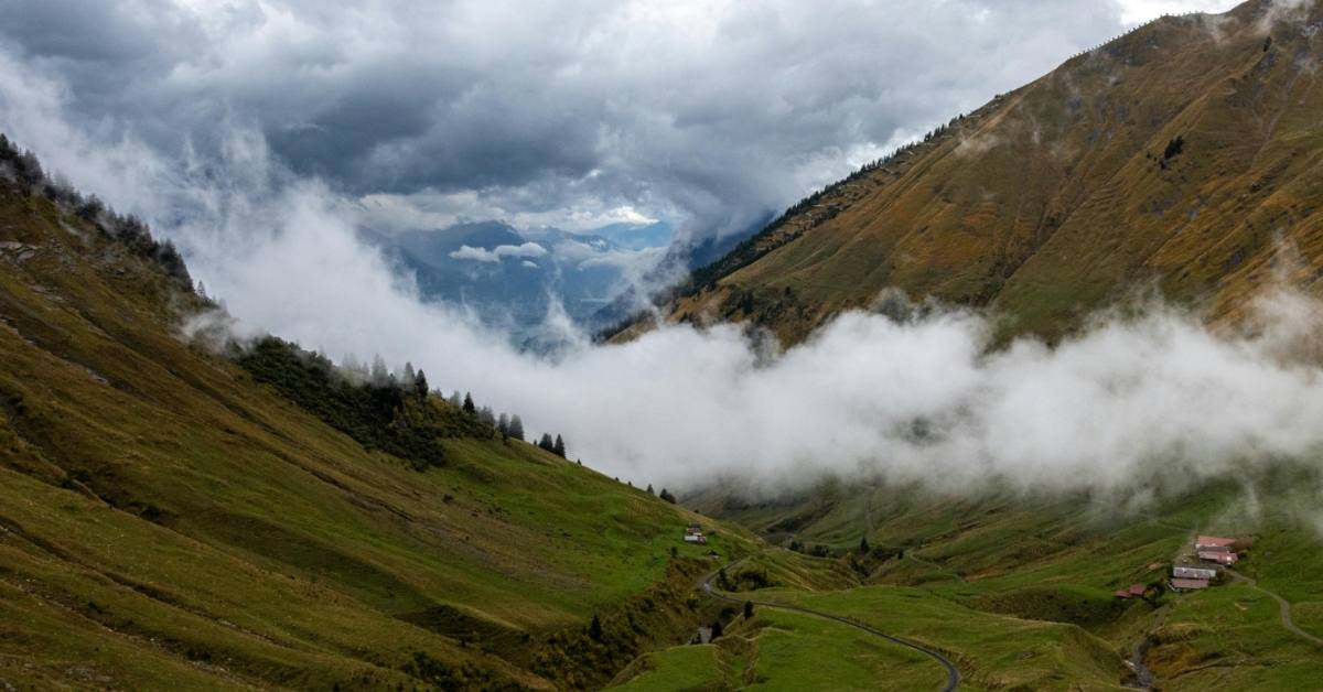 Low-hanging clouds gather on a mountaintop