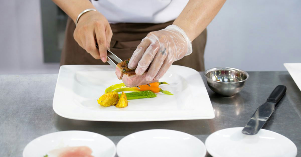 A chef plates a gourmet meal