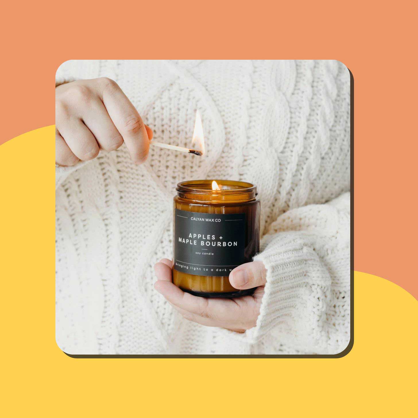 A person lights a Calyan Wax Co candle with a match