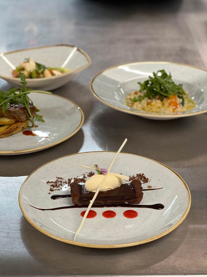 Four plates of gourmet food in a nursing home