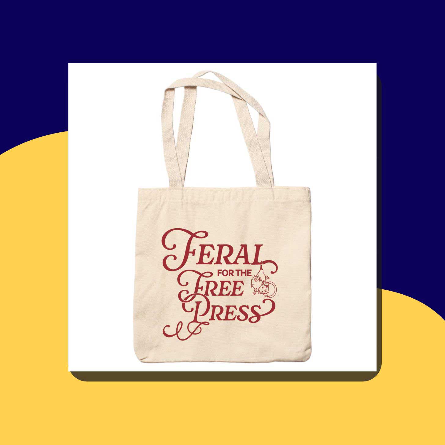A canvas tote bag with red font and illsutration that reads "Feral for the Free Press"