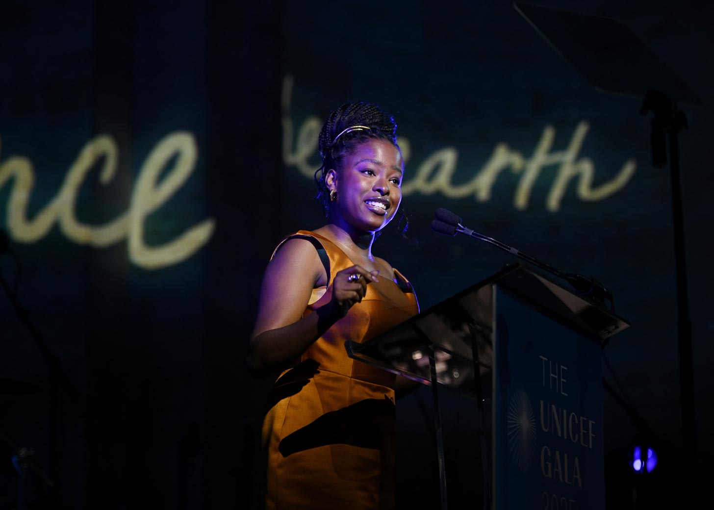 Poet Amanda Gorman performs behind a podium at the UNICEF Gala 2025