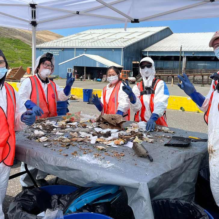 College students sort through trash in a waste management facility in upstate New York