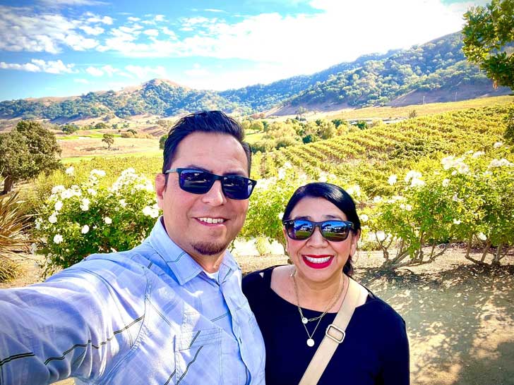 Martin and Irene Garcia take a selfie in a vineyard