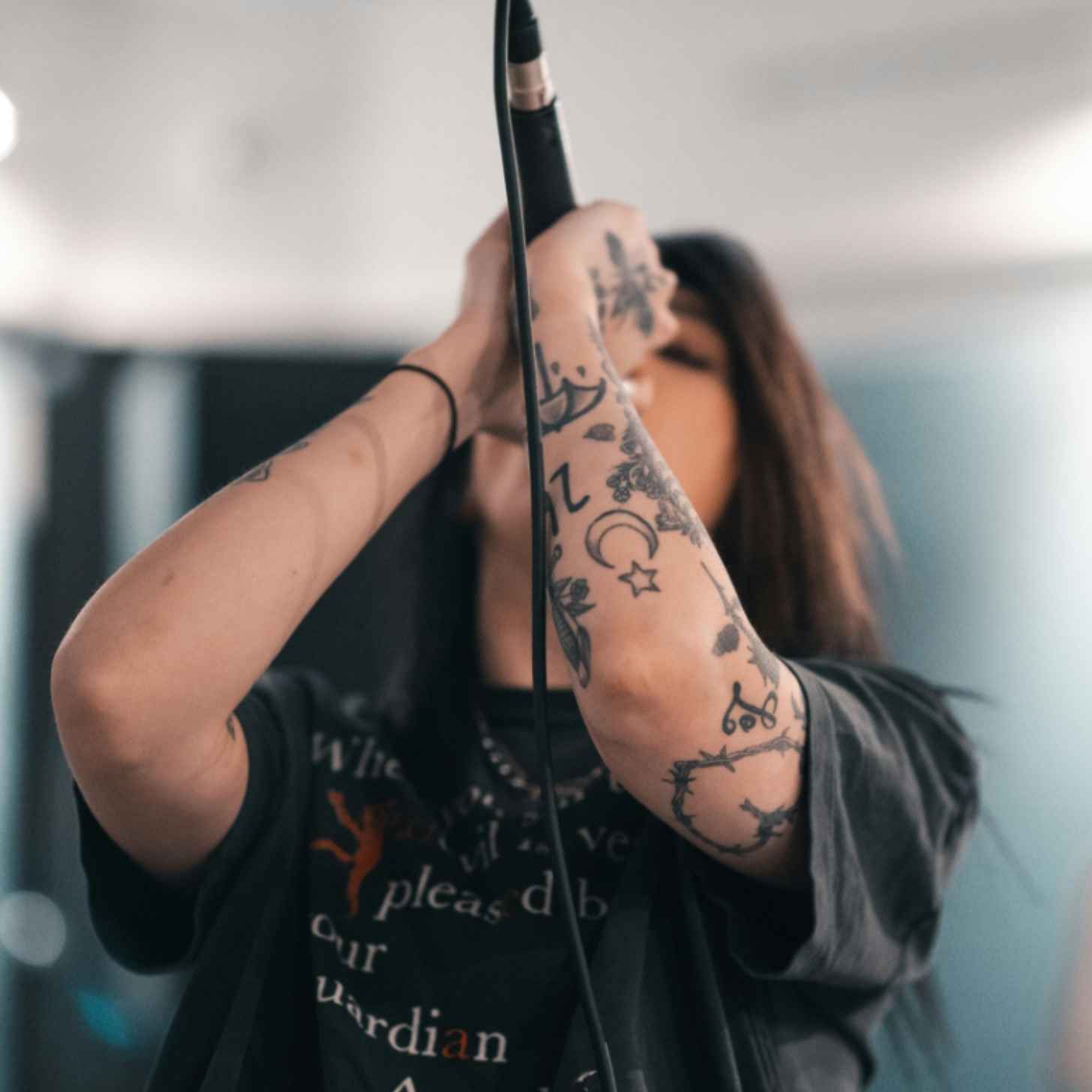 A woman sings into a microphone