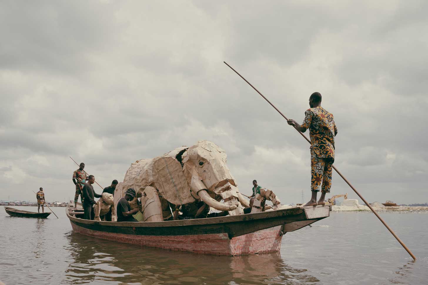 A large cardboard elephant puppet travels by boat in Lagos, Nigeria