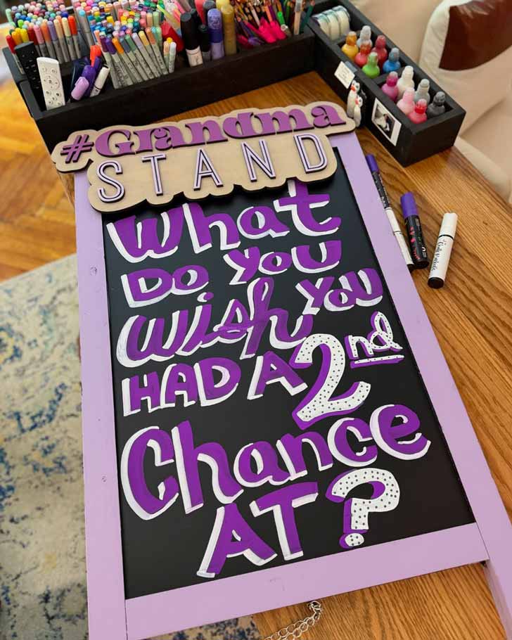 A purple chalk board reads: "What do you wish you had a second chance at?"