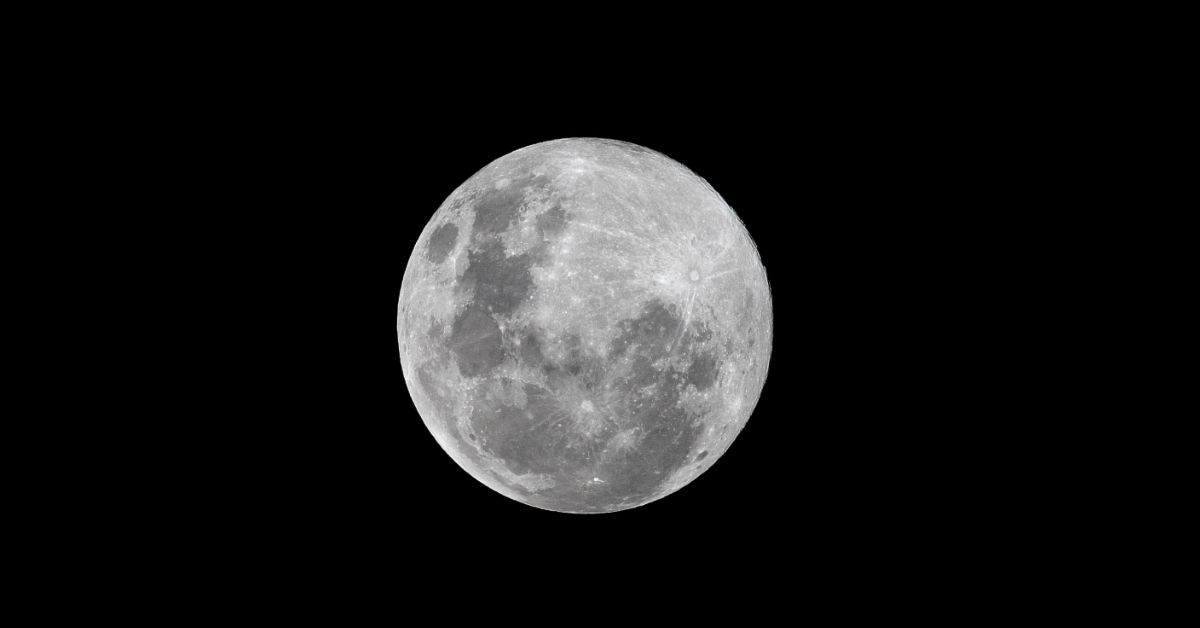 The full moon in an ink black sky.