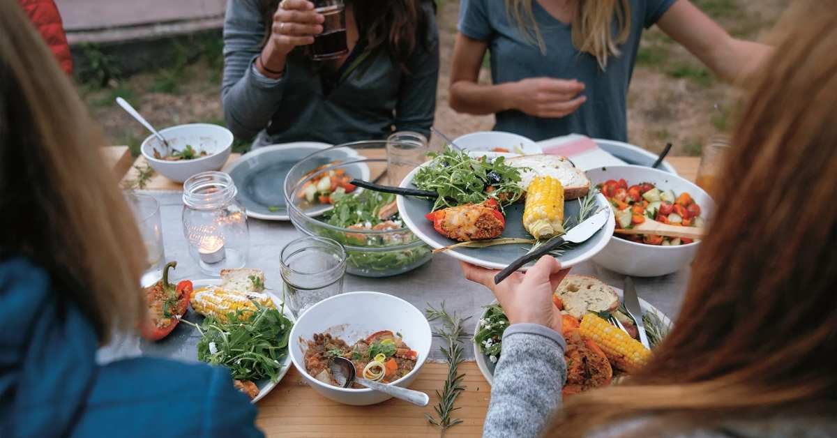 A photo of people eating around a table