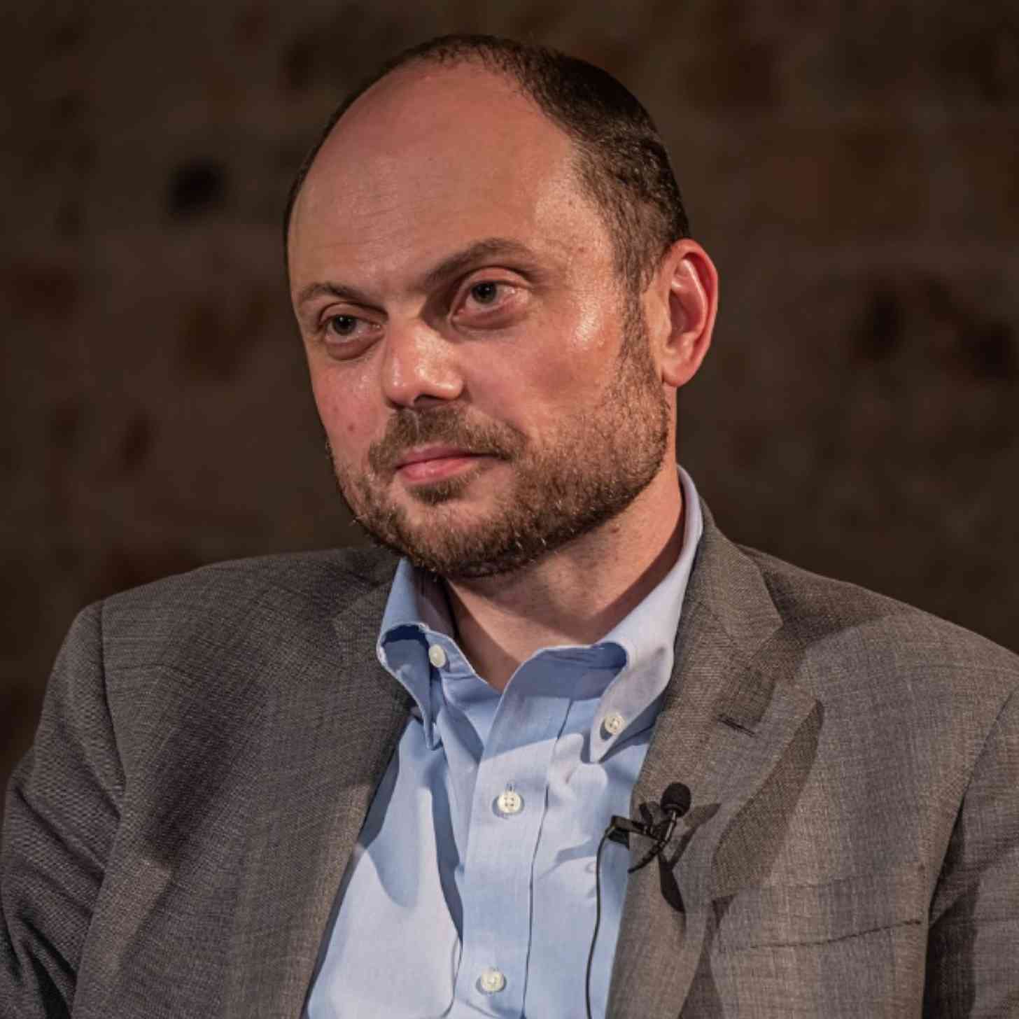 Vladimir Kara-Murza, a Russian man in his 40s, sitting down at a table before a mic