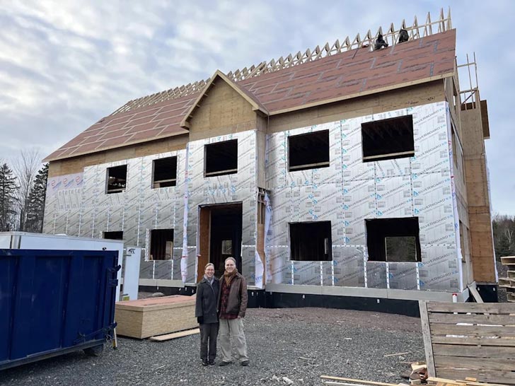 Amy Hendricks and Paul Davie stand in front of a house under construction in Antigonish, Nova Scotia