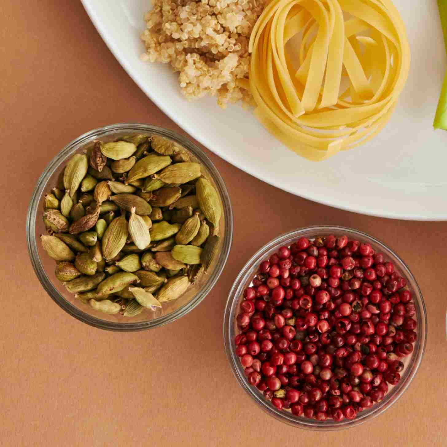 A colorful array of vegan-friendly food displayed on plates and bowls on a wooden tables