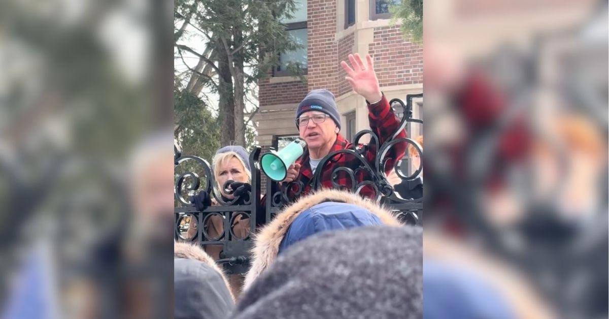 Tim Walz speaks into a megaphone outside of the Minnesota Governor's Mansion