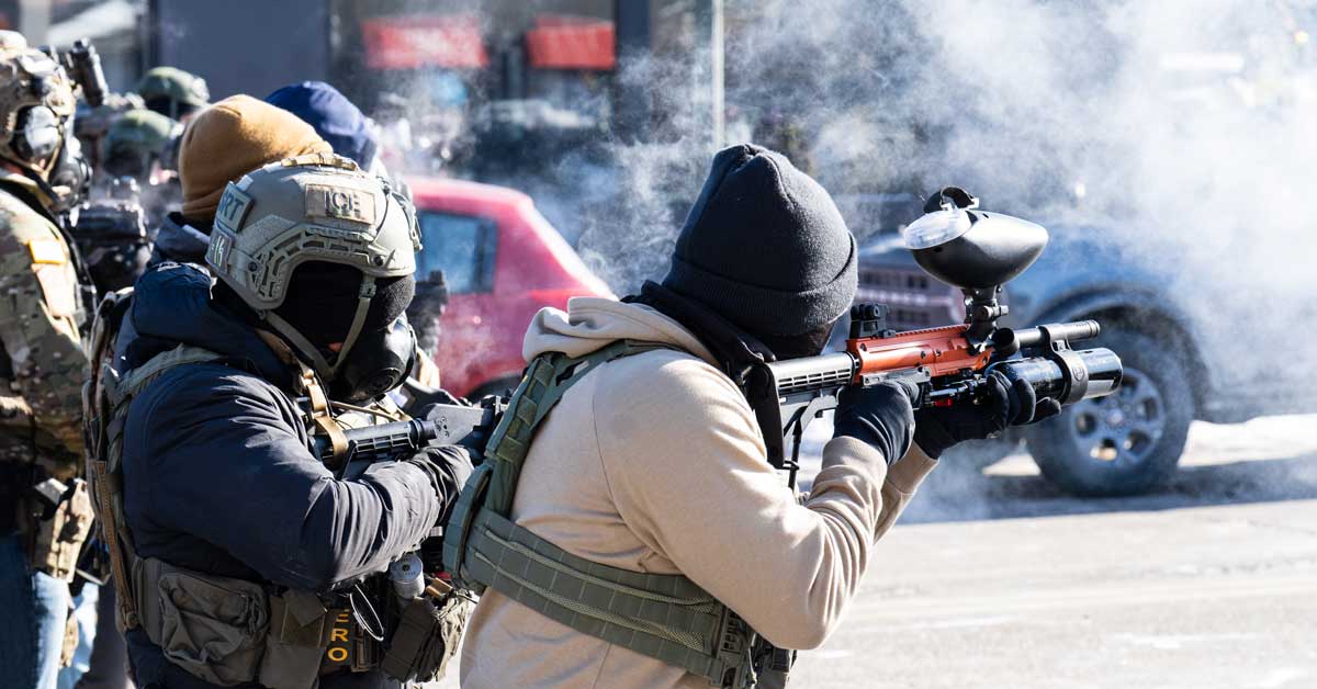 Two ICE agents shoot "less lethal" bullets and tear gas into a crowd of protesters in Minneapolis