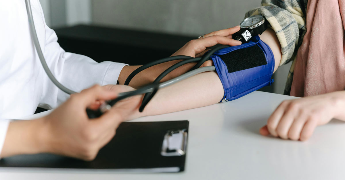 A close-up of a doctor taking a patient's blood pressure
