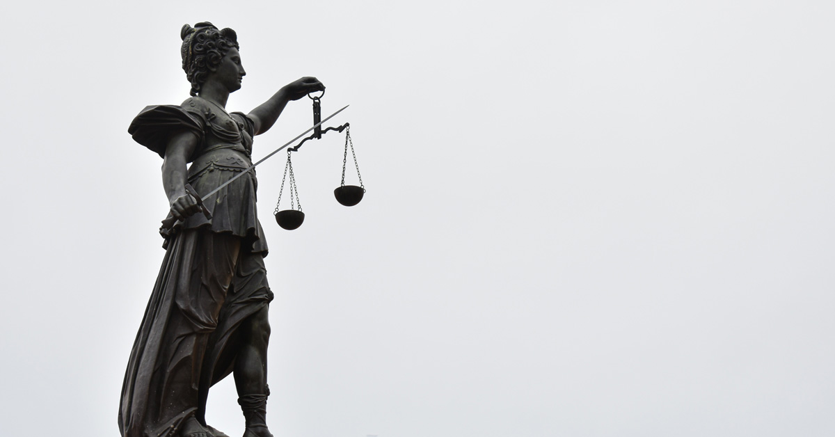 Grayscale photo of a statue of Lady Justice