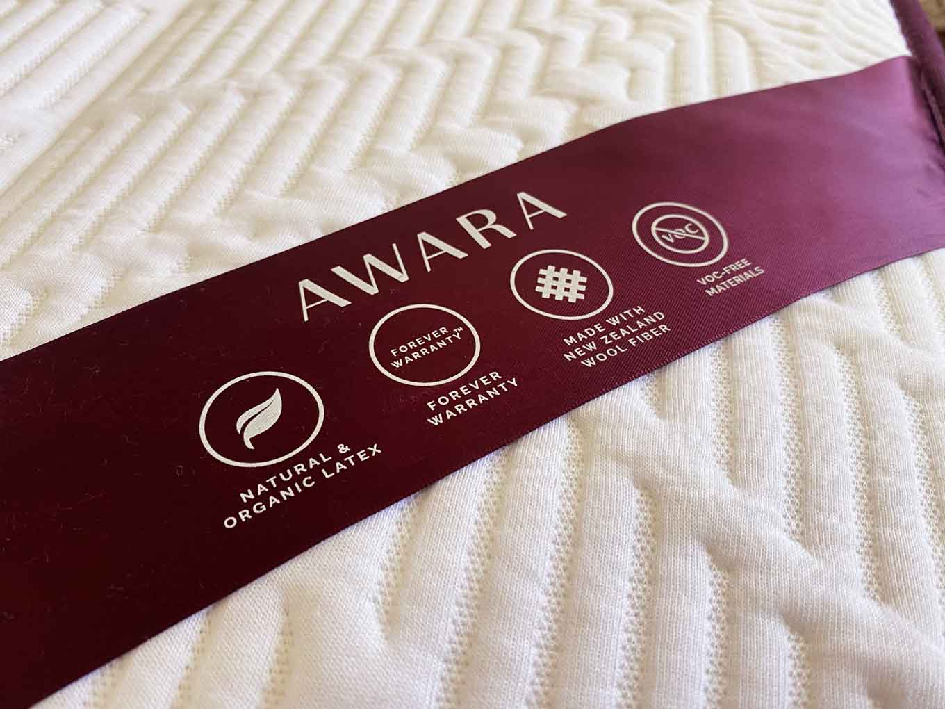 Closeup view of Awara mattress label: Natural and Organic Latex, Forever Warranty, Made with New Zealand Wool Fiber, and VOC-free Materials