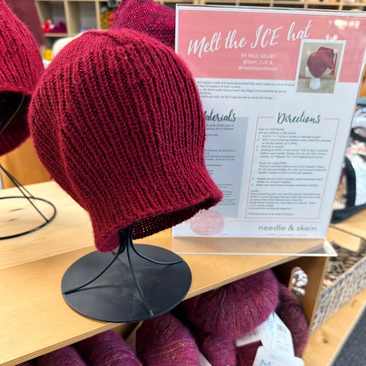 A red knitted "Melt the ICE" protest hat on display in Minnesota yarn shop Needle & Skein