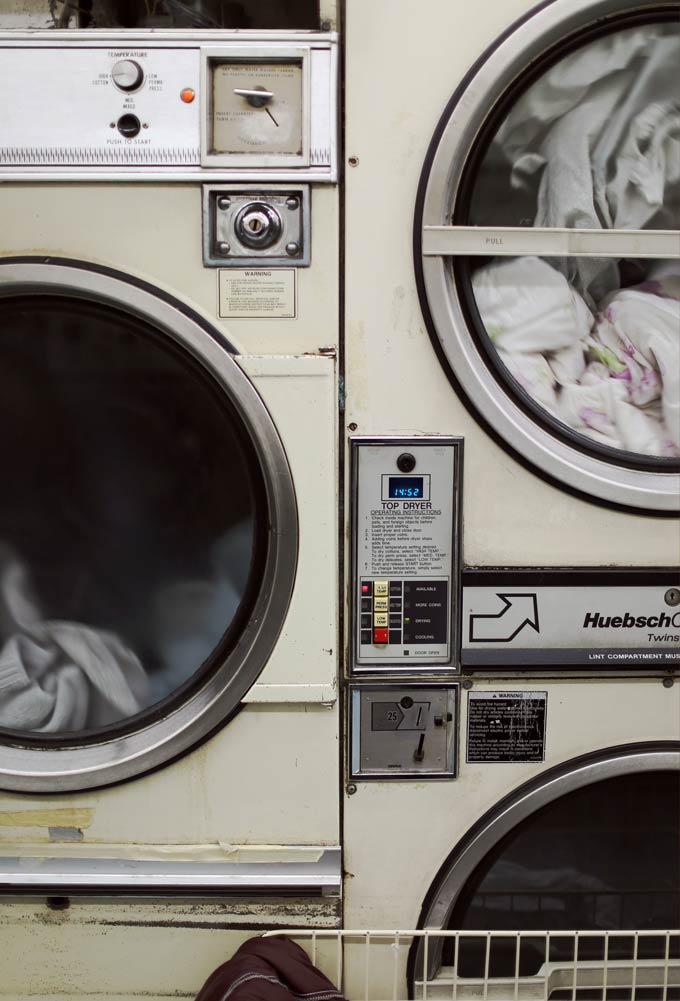 Closeup view of a washer and dryer in a laundromat