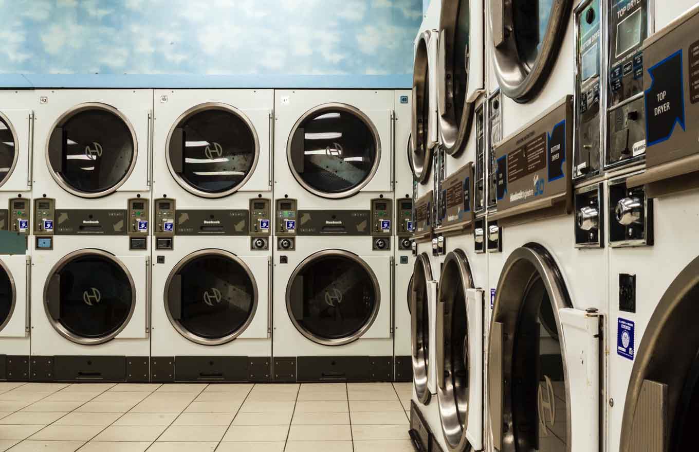 A laundromat with blue cloud wallpaper
