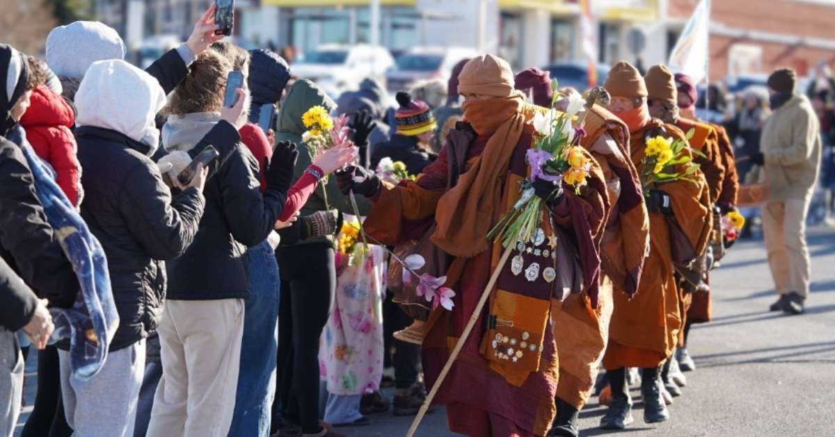 A group of Buddhist monks walk the streets of Alexandria