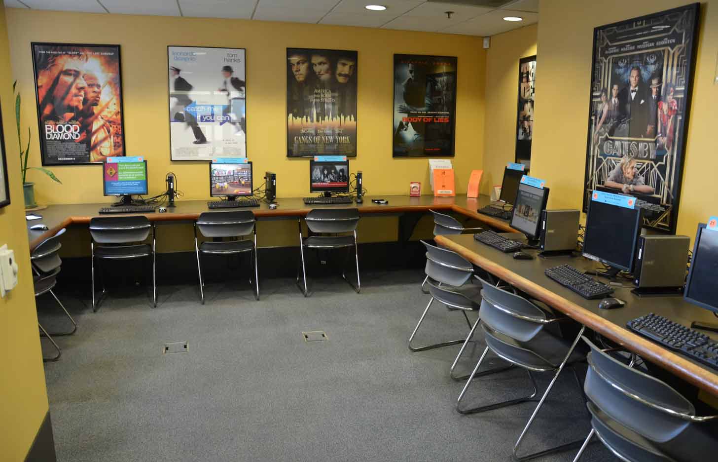 A library computer lab with yellow walls, covered in Leonardo DiCaprio movie posters