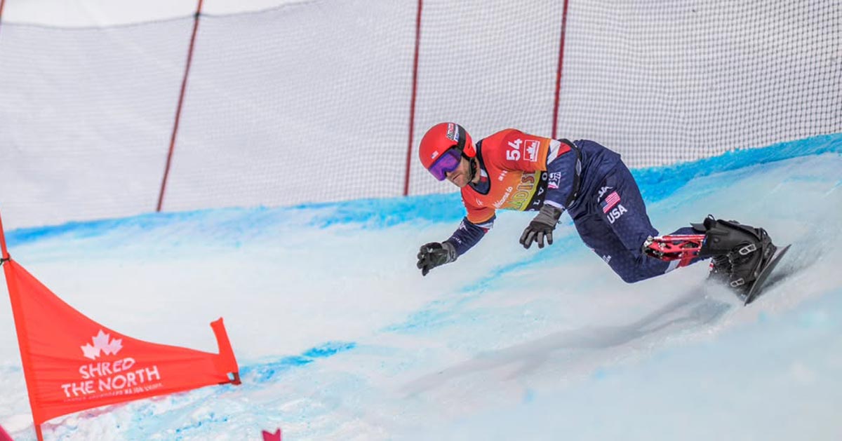 Paralympic snowboarder Mike Schultz weaves between fences on the course