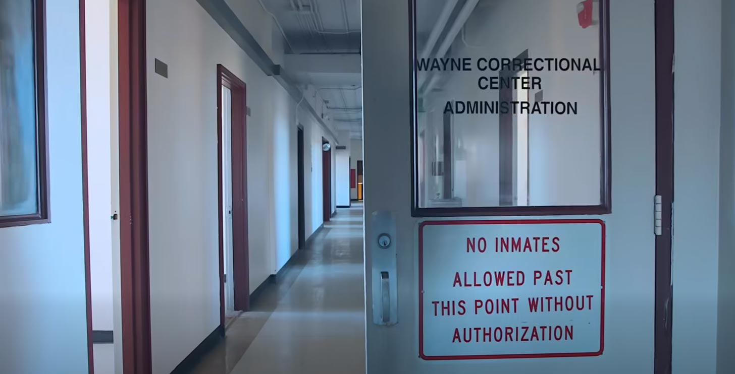 A door into a prison that reads Wayne Correction Center Administration: No Inmates Allowed Past This Point Without Authorization