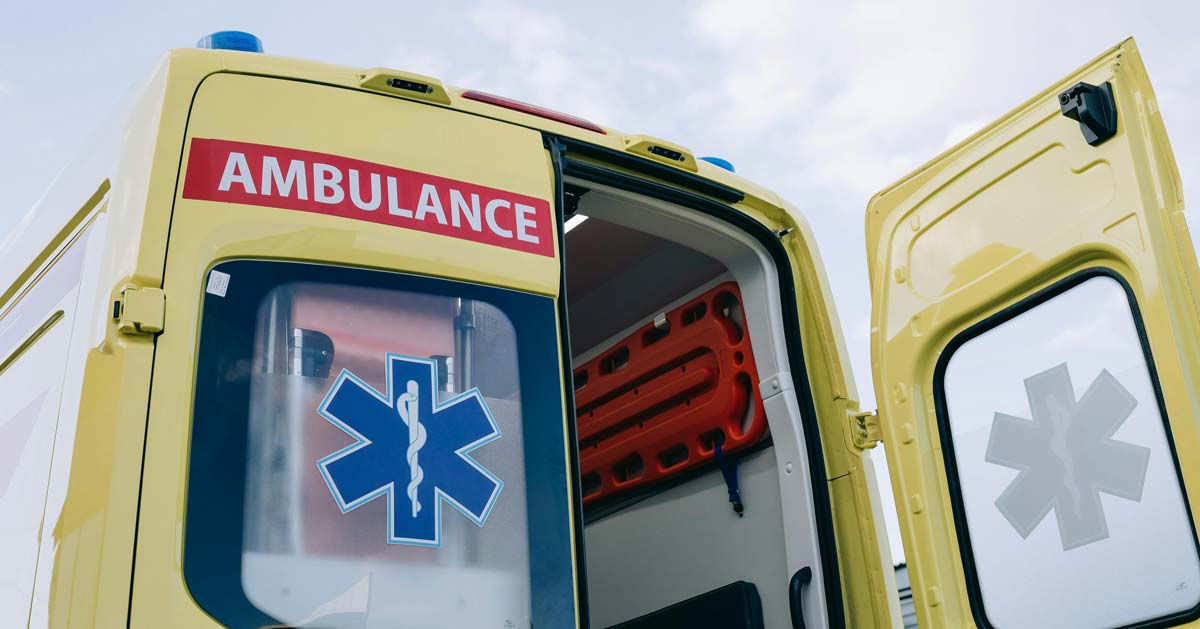 A bright yellow ambulance with its back doors open