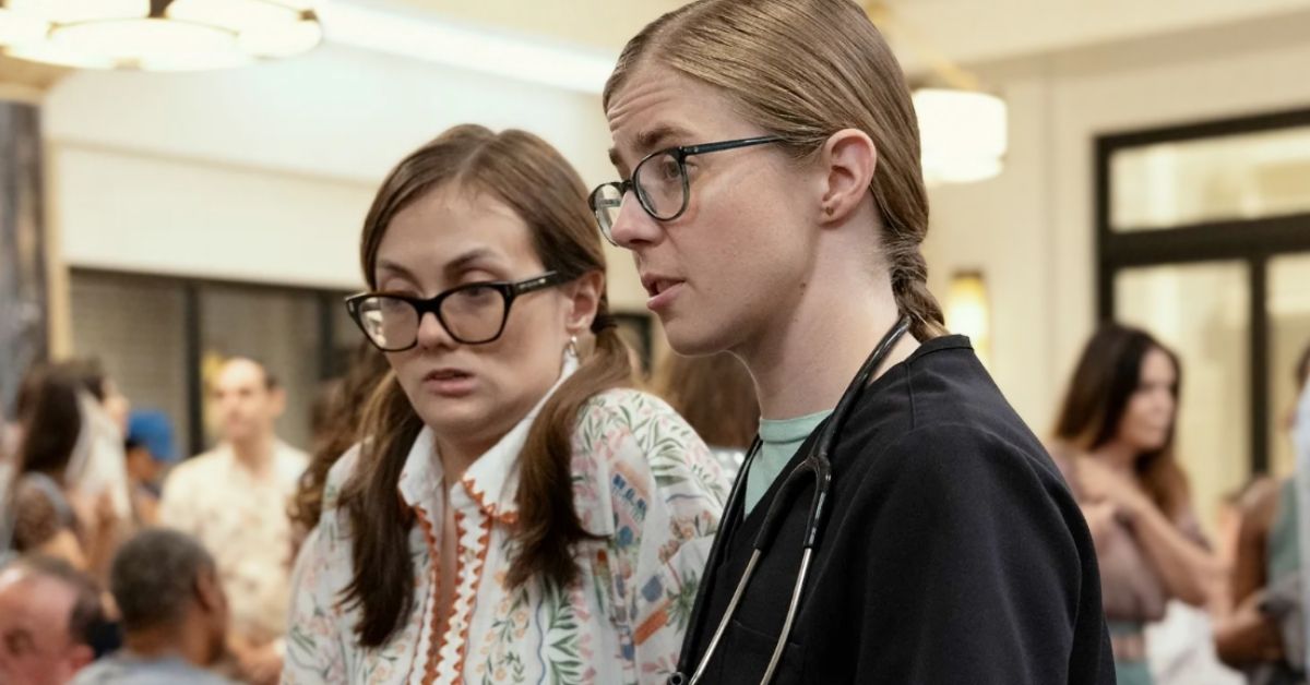Tal Anderson (a young white woman with brown hair and glasses) and Taylor Dearden (a young white woman dressed as a nurse with glasses) in a still from The Pitt 