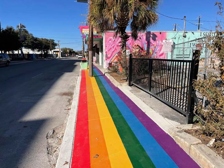 A strip of sidewalk in San Antonio, Texas, is painted with rainbow lines
