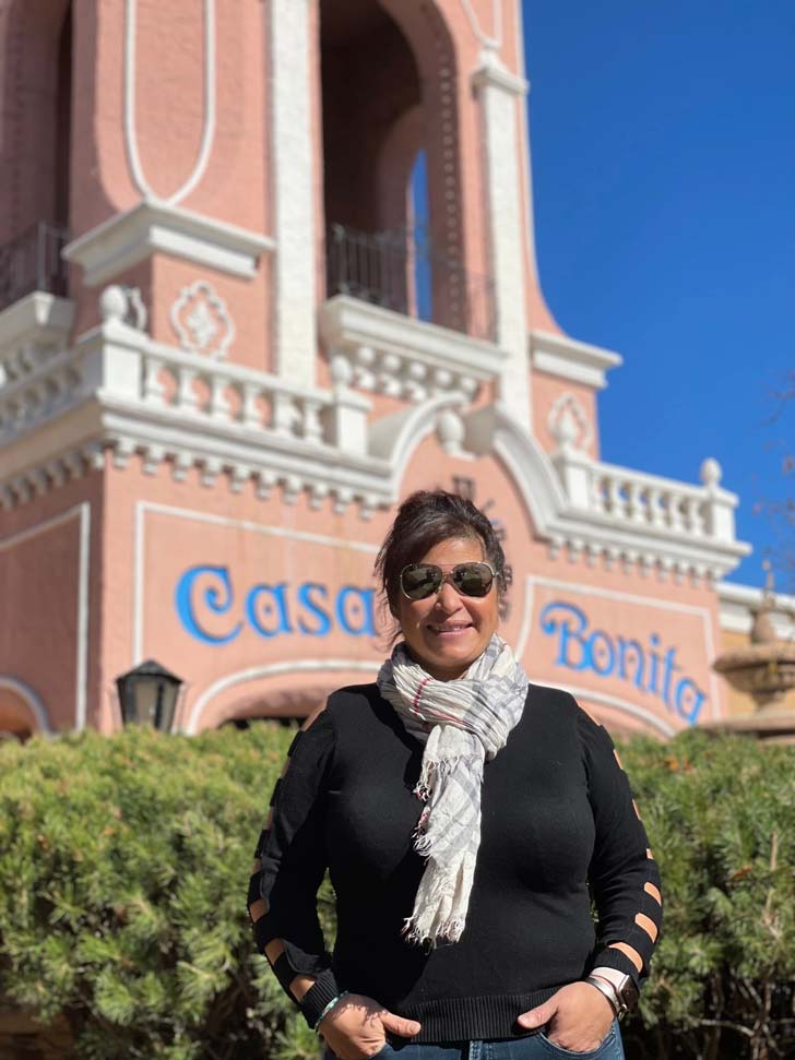 Dana Rodriguez, head chef, smiles outside of Casa Bonita in Denver, Colorado