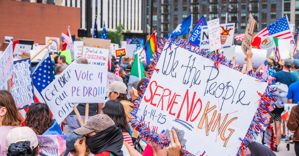 A close-up of a protest sign at "No Kings" in June 2025. The sign reads: "We the people serve no king"