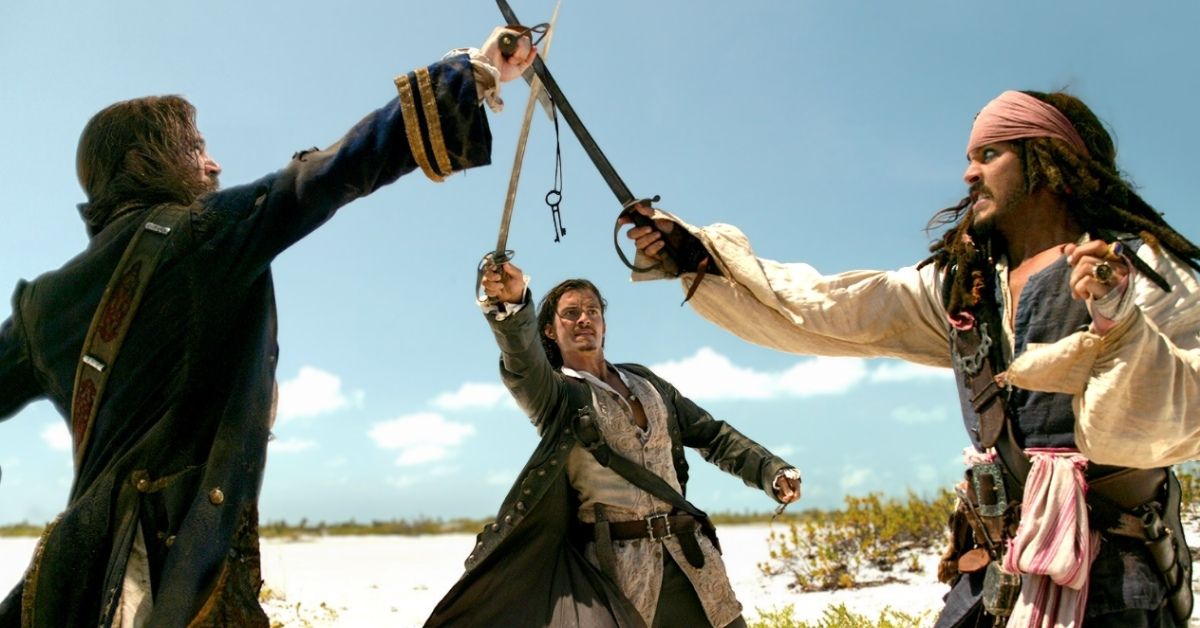 A still from the movie "Pirates of the Caribbean: Dead Man's Chest" with actor Orlando Bloom caught in the middle of a swordfight with Johnny Depp and Jack Davenport.