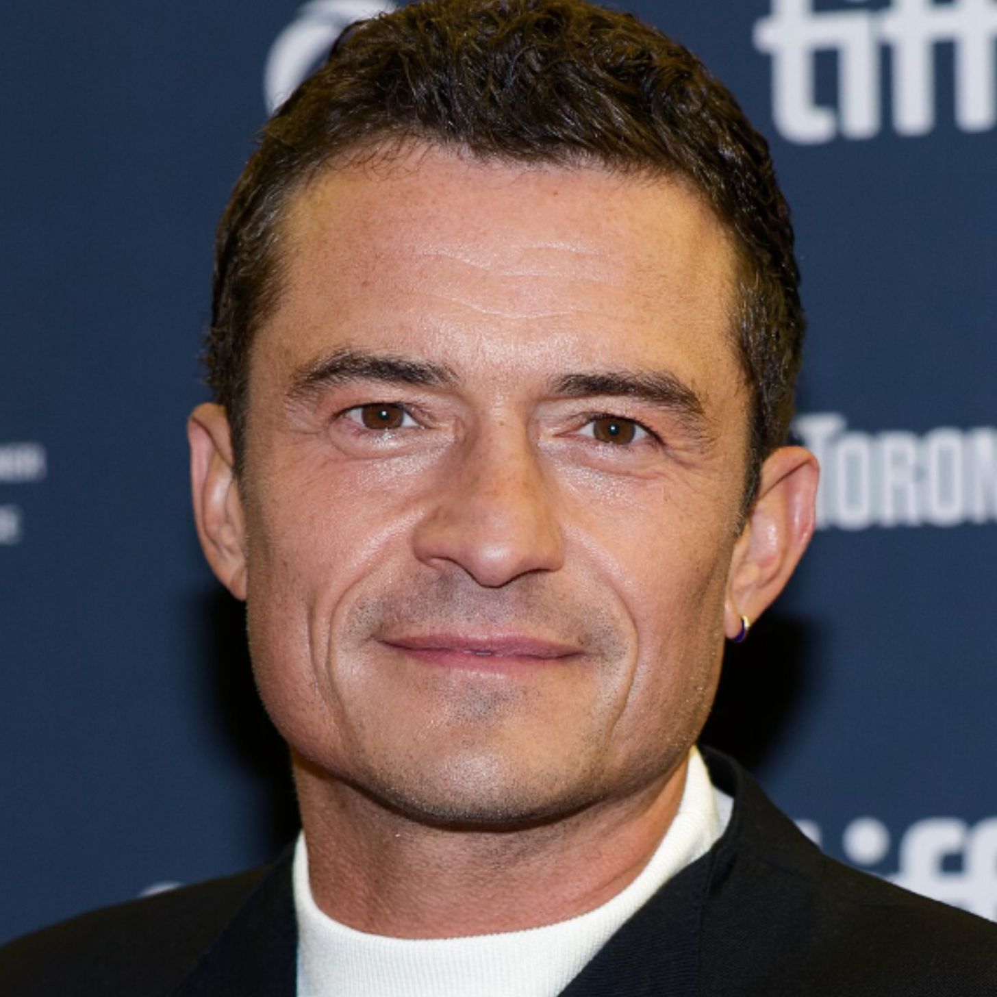 A close-up photo of Orlando Bloom on the Toronto International Film Festival press carpet