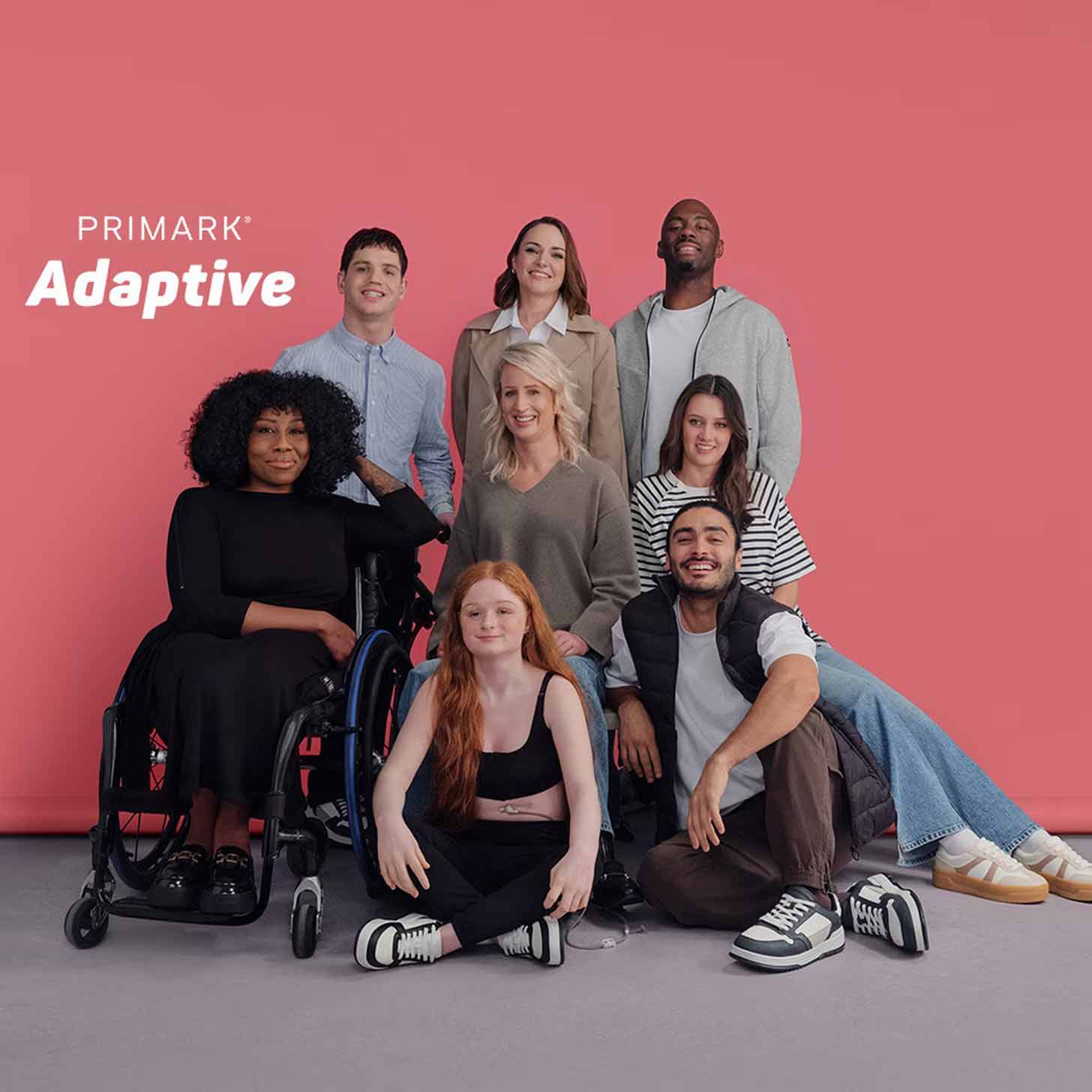 A group of 8 disabled models smiling together in Primark clothes