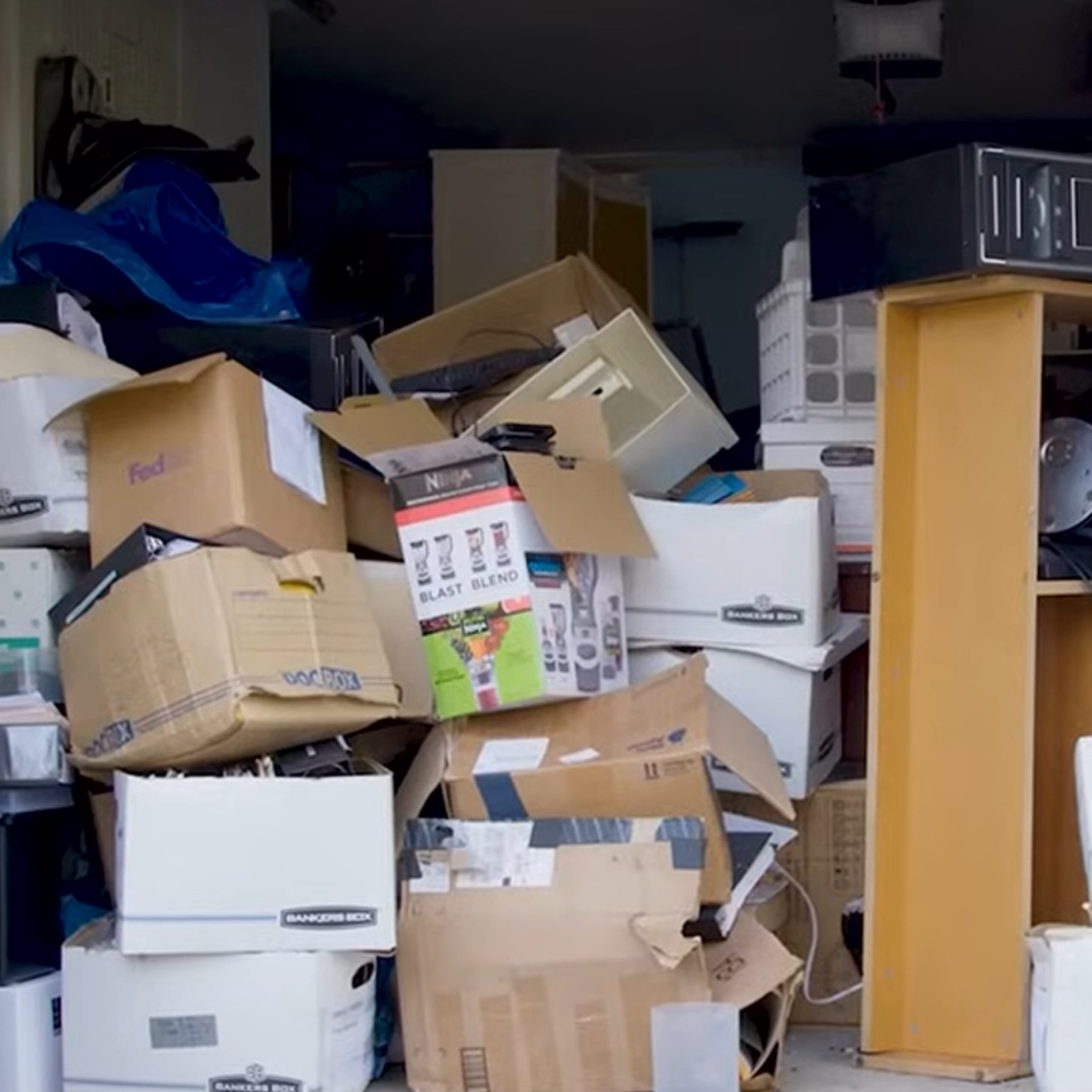 A mixture of clutter, items, and trash in an open garage
