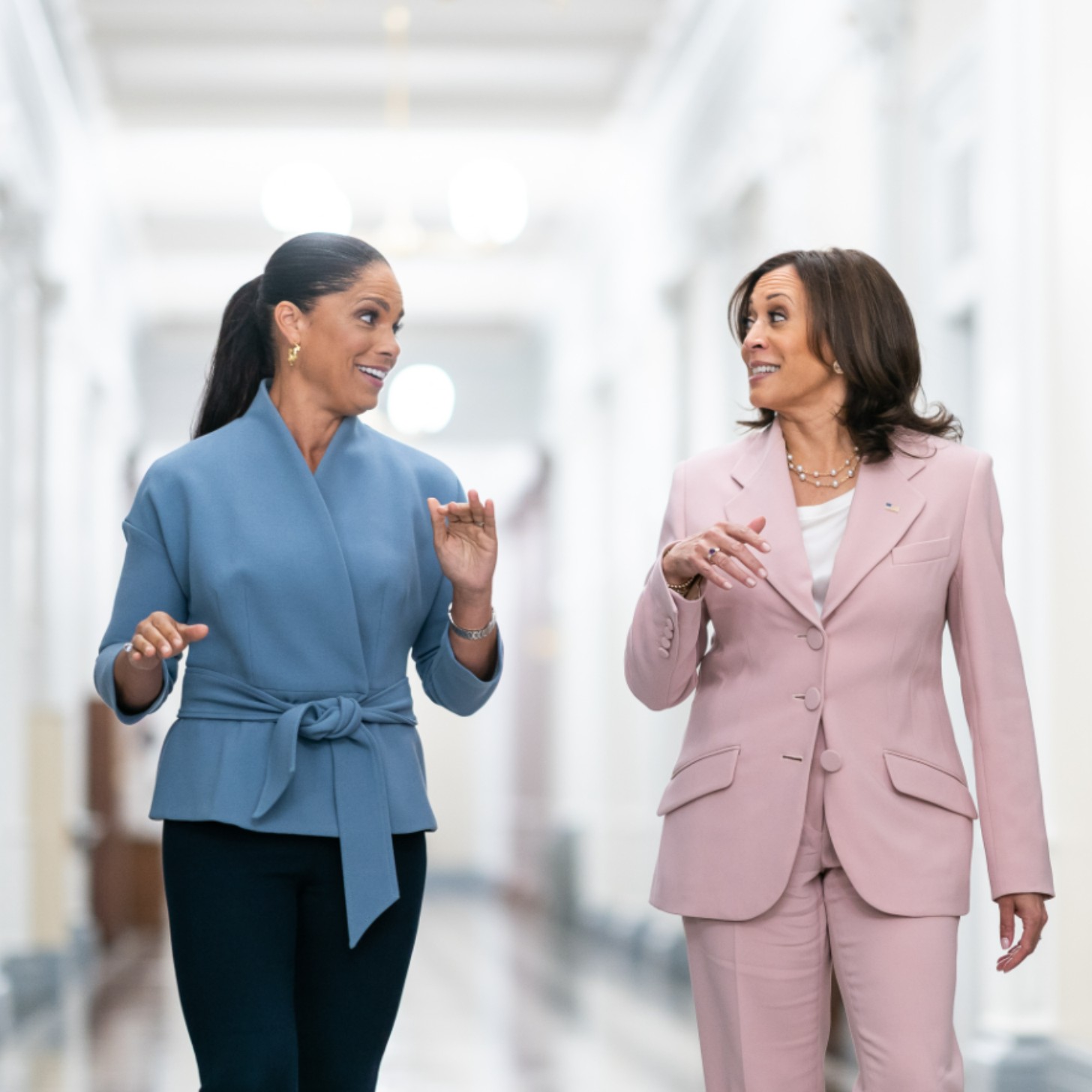 Kamala Harris in a pink suit talking with Soledad O'Brien in a blue belted blazer