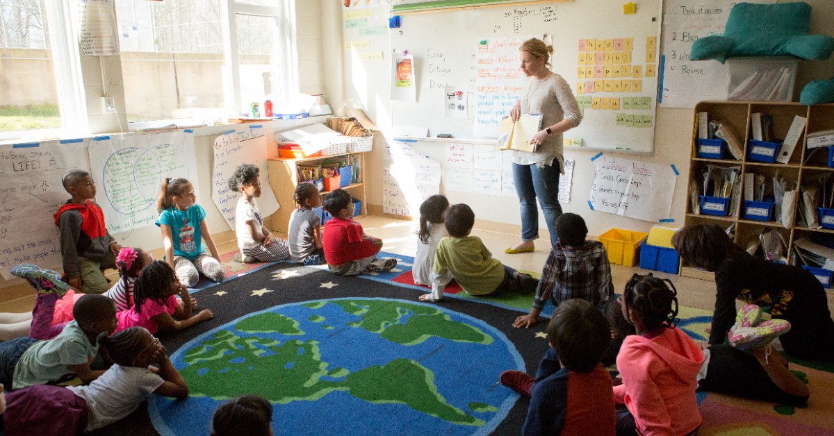 Teacher teaching in front of an elementary school classroom