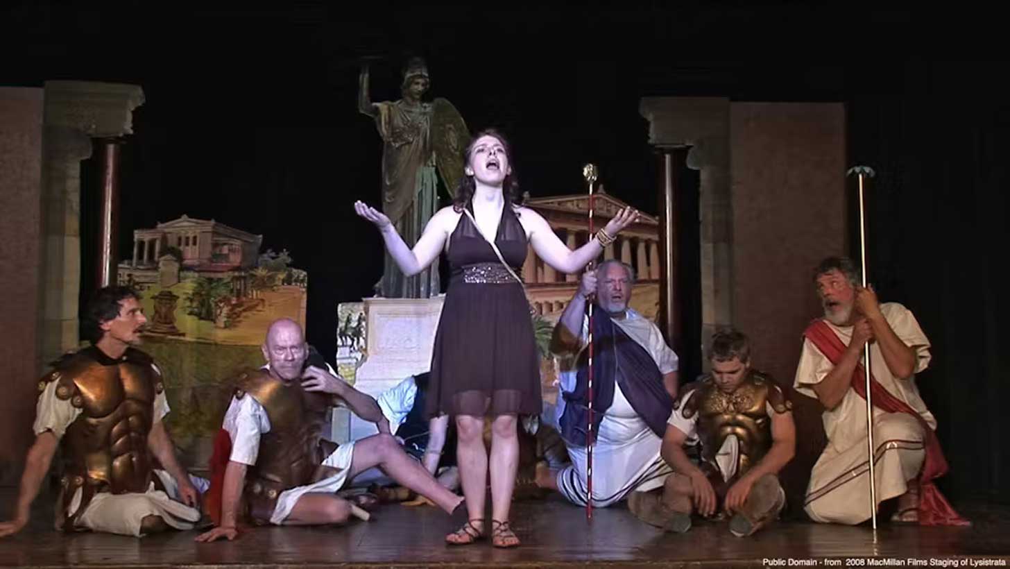 A person performs "Lysistrata" on stage
