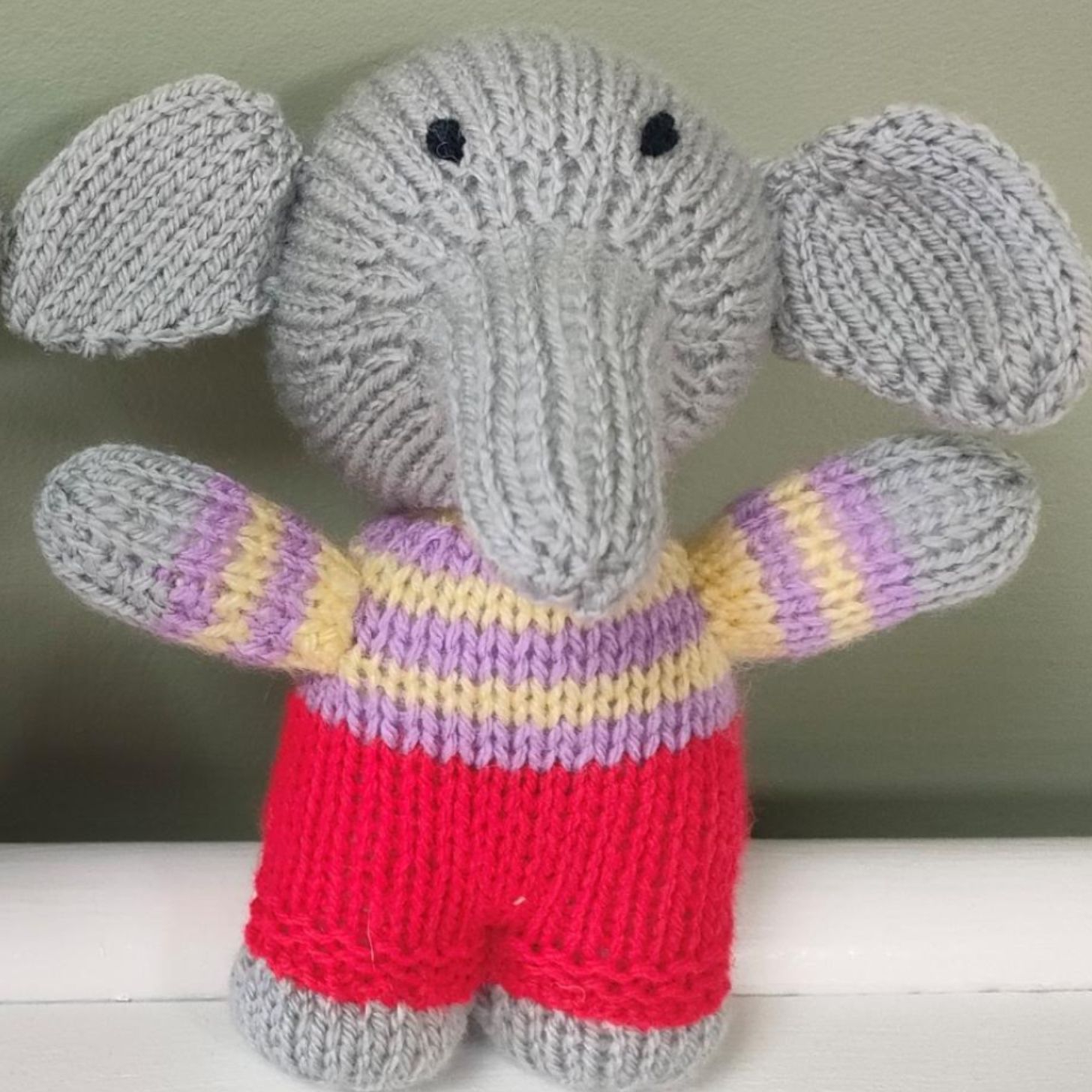A handmade woollen elephant plushie.