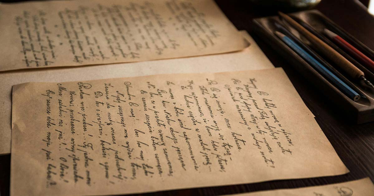 Cursive handwriting on old, worn papers