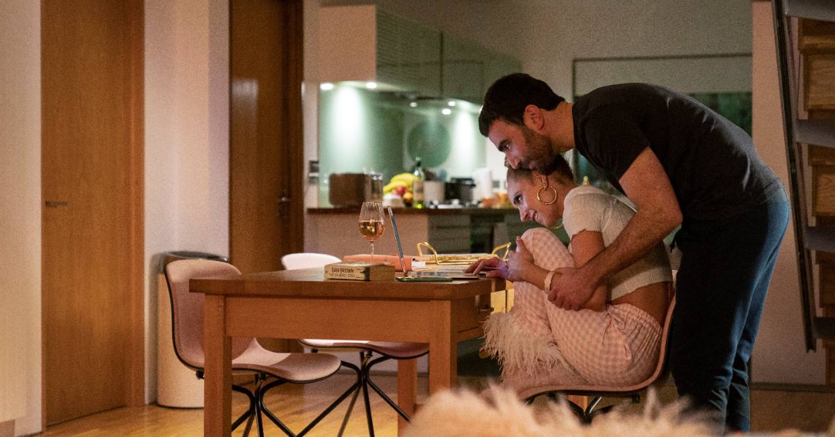 Two characters in Apple TV's "Ted Lasso" snuggle up near a table
