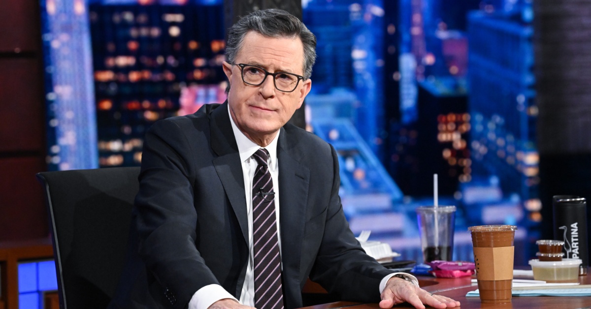 A close-up photo of Stephen Colbert sitting at his 'Late Show' desk